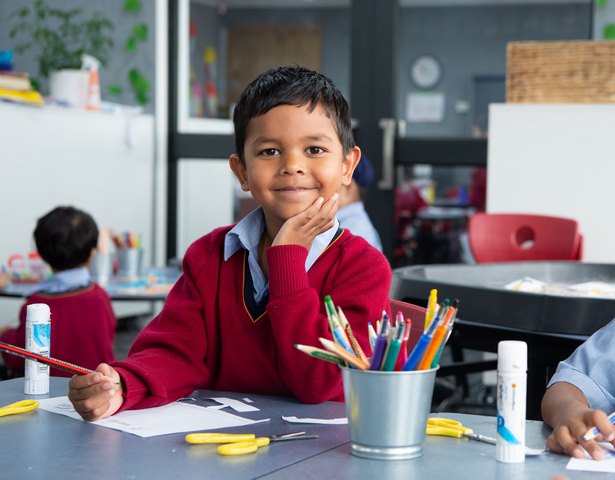 Student Smiles while Drawing