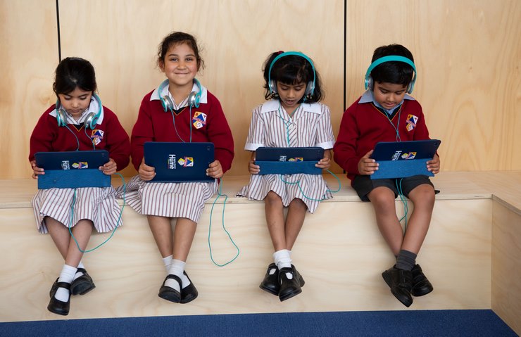 Early Years Students Using Laptops and Headphones