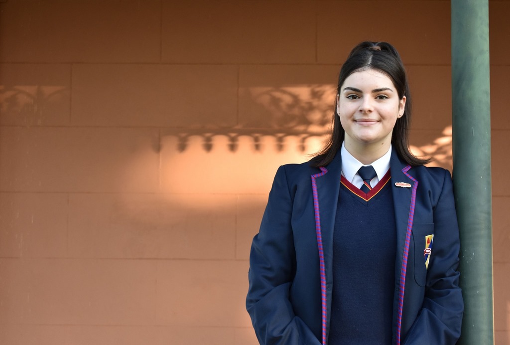 School Girl Leaning Against Pole