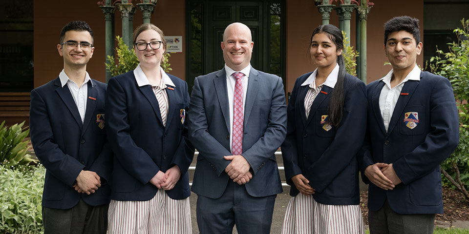 Principal With Students Smiling at Camera