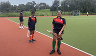 Girls Holding Hockey Stick